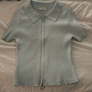 Pastel blue, short sleeve t-shirt with a zip down the whole middle,size medium